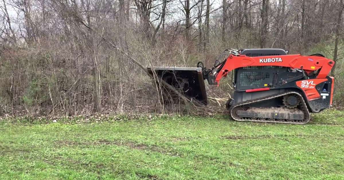 a tractor cutting down trees