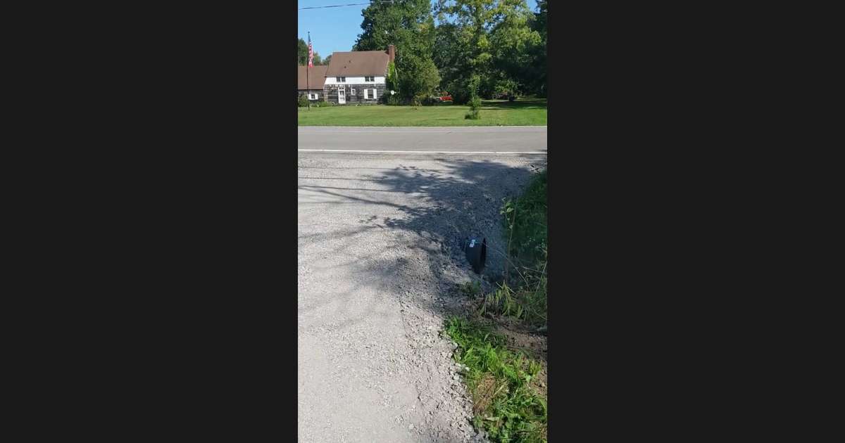 gravel driveway joining an asphalt road